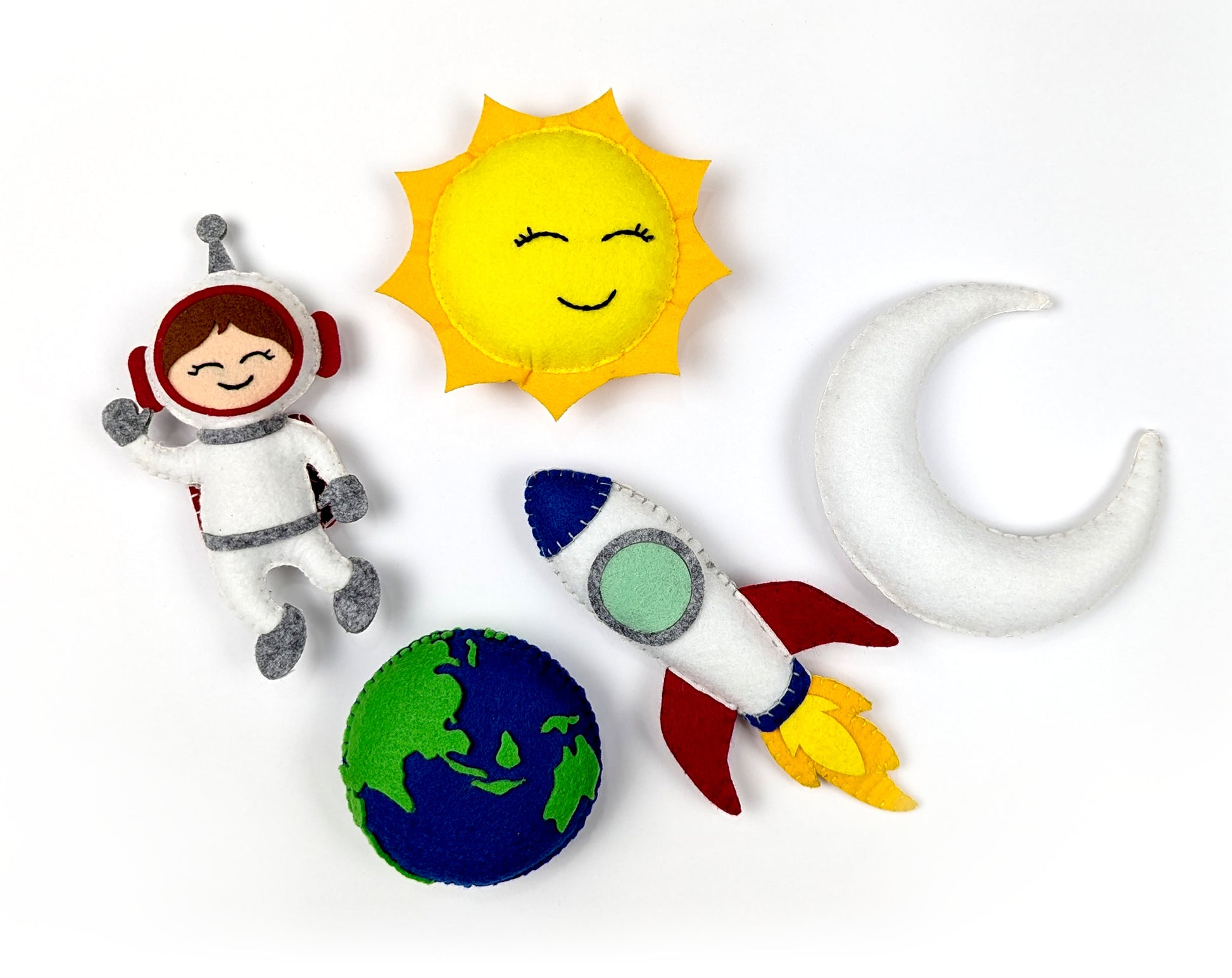 Set of space-themed plush toys including an astronaut, sun, moon, rocket, and planet.