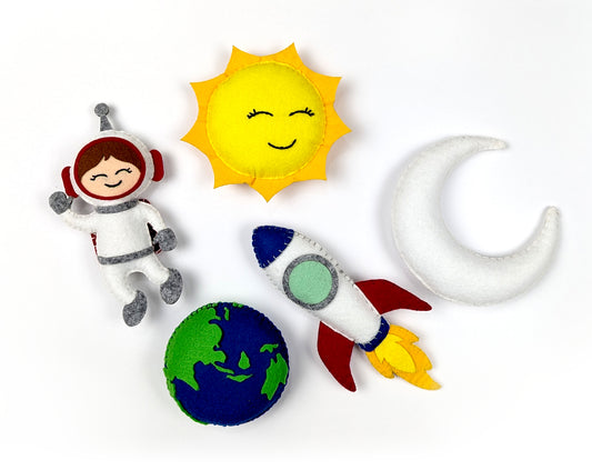 Set of space-themed plush toys including an astronaut, sun, moon, rocket, and planet.